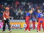 Royal Challengers Bengaluru's Will Jacks (C) celebrates with teammates after taking the wicket of Sunrisers Hyderabad's Travis Head (L) during the Indian Premier League (IPL) Twenty20 cricket match between Sunrisers Hyderabad and Royal Challengers Bengaluru