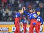 Royal Challengers Bengaluru's Will Jacks (C) celebrates with teammates after taking the wicket of Sunrisers Hyderabad's Travis Head