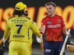 Punjab Kings' captain Sam Curran shakes hands with Chennai Super Kings' MS Dhoni after Punjab Kings won the Indian Premier League cricket match
