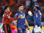 Sunrisers Hyderabad's Abhishek Sharma being congratulated by Lucknow Super Giants' captain KL Rahul and Marcus Stoinis