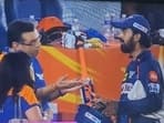 Sanjiv Goenka (L) in an animated chat with KL Rahul