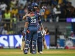 Lucknow Super Giants' Nicholas Pooran (L) is congratulated by captain KL Rahul after scoring a half-century (50 runs) during the Indian Premier League (IPL) Twenty20 cricket match between Mumbai Indians and Lucknow Super Giants 