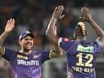Kolkata Knight Riders' Andre Russell (R) celebrates with teammate Sunil Narine after taking a wicket.