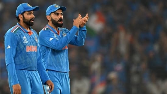 India's captain Rohit Sharma (L) and teammate Virat Kohli celebrate after the dismissal of Australia's Mitchell Marsh 