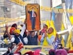 Delhi Chief Minister and Aam Aadmi Party (AAP) National Convener Arvind Kejriwal holds up a portrait of Dr. BR Ambedkar along with Punjab CM Bhagwant Mann during a roadshow in Patiala, Punjab.