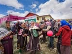 Women celebrate after casting their votes at the world's highest polling station located at an altitude of 15,256 feet in Tashigang, Lahaul and Spiti, Himachal Pradesh.