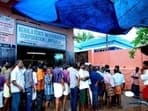 People queue up outside a liquor outlet in Thiruvananthapuram, Kerala,