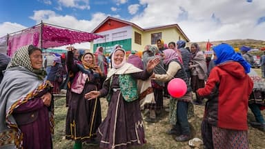 Women celebrate after casting their votes at the world's highest polling station located at an altitude of 15,256 feet in Tashigang, Lahaul and Spiti, Himachal Pradesh.