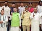 Prime Minister Narendra Modi shows a victory sign while posing for a group picture with Bihar chief minister Nitish Kumar, Telugu Desam Party (TDP) chief N Chandrababu Naidu, defence minister Rajnath Singh, BJP president JP Nadda, Jana Sena Party chief Pawan Kalyan and others at his residence, 7, LKM, in New Delhi on Wednesday. 