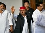 Samajwadi party president Akhilesh Yadav gestures to supporters upon his arrival for a meeting of opposition alliance,