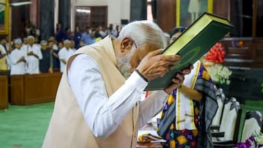 Prime Minister Narendra Modi pays respects to the Constitution of India as he attends the NDA Parliamentary Party meeting at Samvidhan Sadan, in New Delhi, Friday