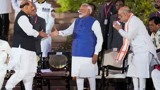 Prime Minister Narendra Modi being greeted by BJP MP Rajnath Singh at the swearing-in ceremony of the new Union government, at Rashtrapati Bhavan in New Delhi, Sunday.