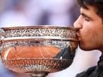 Spain's Carlos Alcaraz kisses the trophy after winning the French Open.