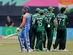 India's Ravindra Jadeja, left, walks off the field after losing his wicket against Pakistan