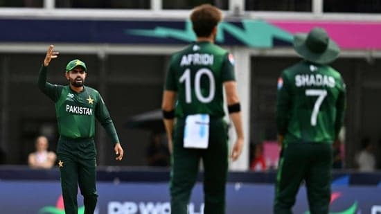 Pakistan's Shaheen Shah Afridi discusses with teamates after challenging the decision of the empire