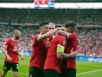Austria's Marko Arnautovic , center, is embraced by teammates after scoring a goal during a Group D match against Poland.