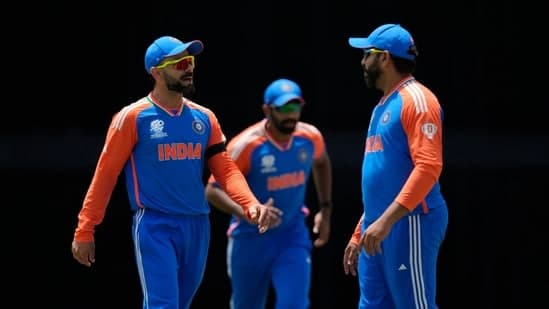 India's Virat Kohli, left, speaks to captain Rohit Sharma, right, during the ICC Men's T20 World Cup cricket match between Afghanistan and India