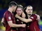 Belgium's Kevin De Bruyne reacts with Jan Vertonghen and Arthur Theate after the match