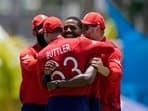 England's Chris Jordan, second right, celebrates with teammates after getting a hat-trick by dismissing United States' Saurabh Nethralvakar