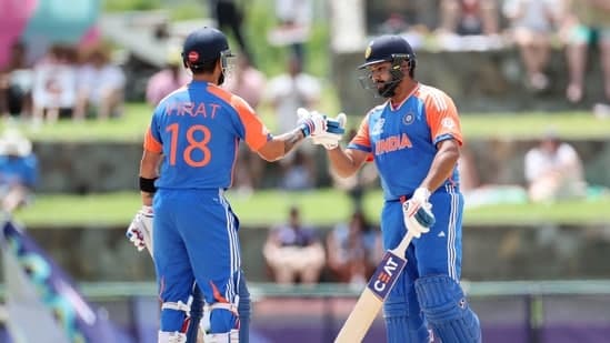 India's captain Rohit Sharma (c) and Virat Kohli celebrate their partnership during the Super 8 Group 1 match against Bangladesh
