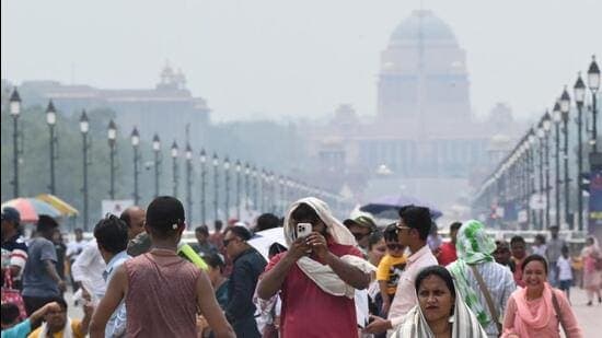 People walk along the Kartavya Path among humid conditions on Sunday. (Arvind Yadav/HT Photo)