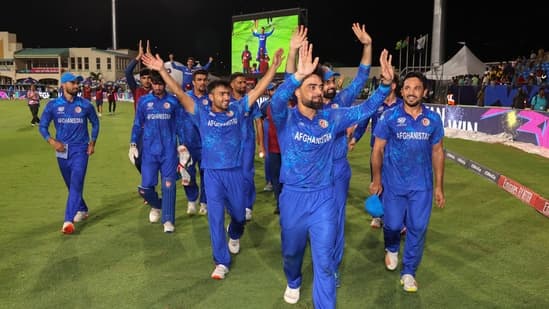 Afghanistan's captain Rashid Khan, with teammates, acknowledges fans after advancing to the ICC Men's T20 World Cup semis by beating Bangladesh