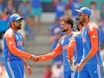 India's Rohit Sharma (c) and Kuldeep Yadav celebrate the dismissal of Australia's Glenn Maxwell during their Super 8 Group 1 match in the ICC Mens T20 World Cup 2024, at Daren Sammy National Cricket Stadium, Gros Islet
