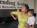 Kavita Medhar juggles while holding her baby.