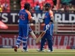 India's captain Rohit Sharma, left, and Virat Kohli celebrate scoring runs during the ICC Men's T20 World Cup second semifinal cricket match between England and India at the Guyana National Stadium in Providence, Guyana