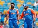 India's Jasprit Bumrah and Rohit Sharma (c) celebrate a wicket.