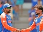 India's Rohit Sharma (c) and Kuldeep Yadav celebrate the dismissal of Australia's Glenn Maxwell during their Super 8 Group 1 match in the ICC Mens T20 World Cup 2024
