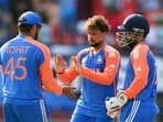 India's captain Rohit Sharma and Kuldeep Yadav celebrate a wicket during the semi-final match against England in the ICC Mens T20 World Cup 2024