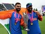 India's Virat Kohli and captain Rohit Sharma celebrate with the trophy after winning the ICC men's Twenty20 World Cup 2024 final