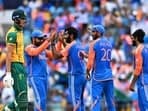 India's Jasprit Bumrah (C) celebrates with teammates.
