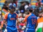 India's Virat Kohli, right, and teammate Axar Patel touch gloves as they bat during the ICC Men's T20 World Cup final cricket match.