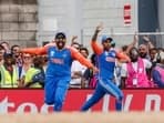 India's Rohit Sharma (C) and Suryakumar Yadav celebrating a wicket during the T20 World Cup final.
