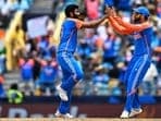 India's Jasprit Bumrah celebrates with teammate Virat Kohli during T20 World Cup final.