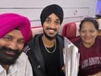 Arshdeep Singh with his parents inside the special Air India flight from Barbados. 