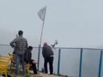 At Bhadraj Temple, a worker was filmed throwing shoes off the hillside.