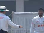 The umpire reprimands Shakib Al Hasan after he throws the ball towards Mohammad Rizwan