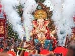 Devotees carry the idol of Lord Ganesha as the celebrations for Ganesh Chaturthi begin. 