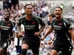 Arsenal's Gabriel, center, celebrates after scoring the opening goal during the English Premier League soccer match between Tottenham Hotspur and Arsenal in London.