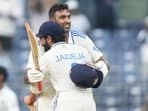 India's Ravichandran Ashwin celebrates after scoring a century with Ravindra Jadeja.