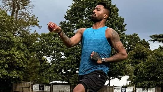 Hardik Pandya bowling with a red ball.