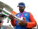 Rohit Sharma poses for a picture with the trophy after Team India won the ICC Mens T20 World Cup 2024 