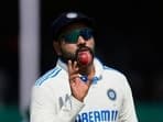 India's captain Rohit Sharma catch a ball on the fourth day of the second cricket test match between Bangladesh and India in Kanpur.