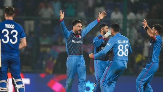 Rashid Khan celebrates with team-mates after Afghanistan beat England in a group match of 2023 World Cup in Delhi.