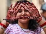 This year, Karwa Chauth will be celebrated on October 20, Sunday, A woman shows her hands decorated with henna, ahead of the Karwa Chauth festival in Jammu on Friday.