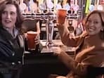 Kamala Harris and Michigan Governor Gretchen Whitmer enjoy beer at a bar.