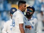 India's Captain Rohit Sharma and Ravichandran Ashwin celebrate the wicket of New Zealand's Glenn Phillips